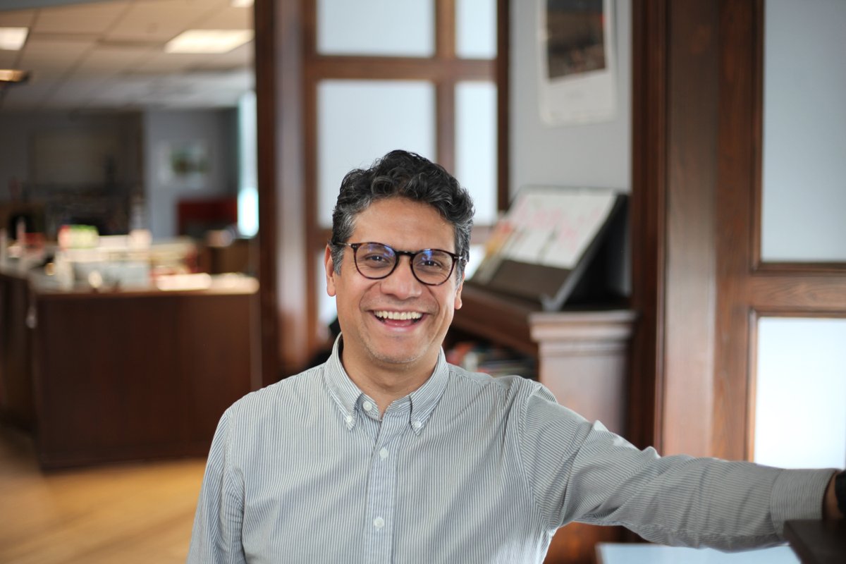 Candid portrait of a man gesturing indoors